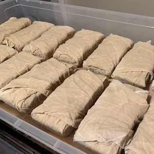 The cakes were wrapped in clean cheesecloth, ready to be soaked in some cognac.
